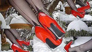 Red spike heels dangling in the snow