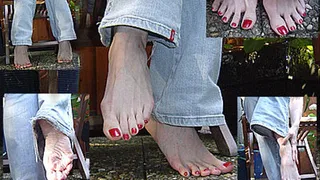 Relaxing barefeet red toe nails