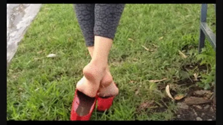 New red suede flats at a park bench