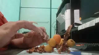 Eating fruit using long nails