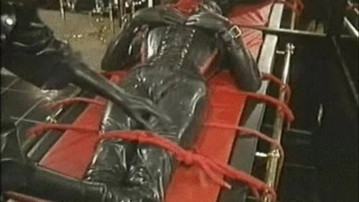 Rubber slaveslut assfucked with a whip handle