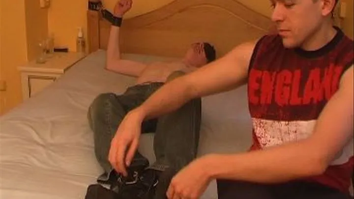 John M tied to the bed blindfolded wearing black socks.