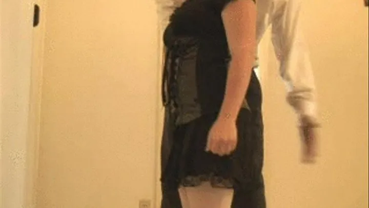 spanked over skirt while standing (side view)