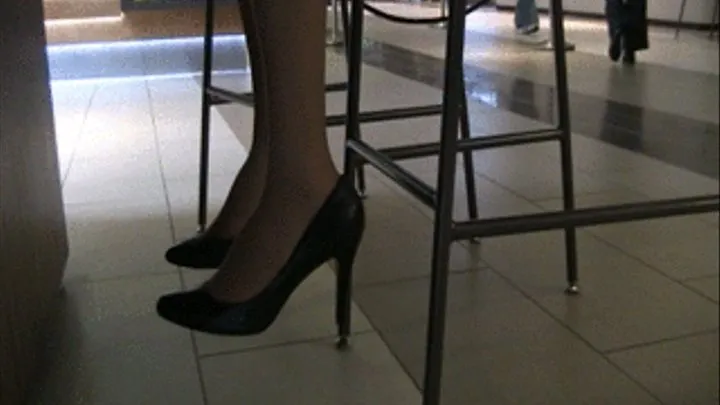 Black heels & nylons at a mall barstool