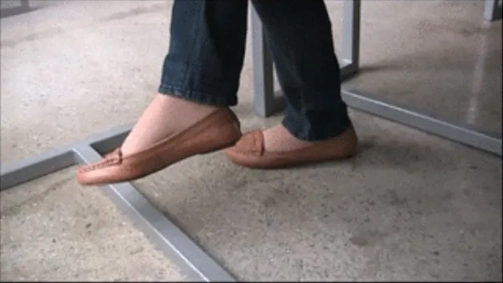 Brown loafers & nylons under table