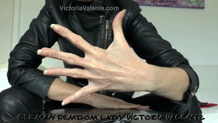 Leather mistress shows her beautiful hands