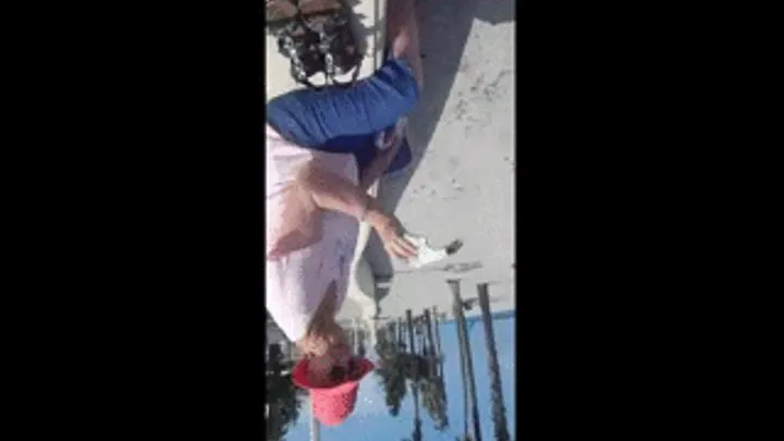 barefoot Granny Dangles her sandals at the beach