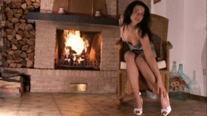 Mistress Alexis in front of a open fire