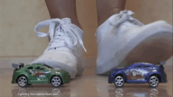 Two small Cars under white Sneakers