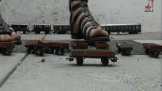 Train wagons under Sandals and wooden Clog (floor view)