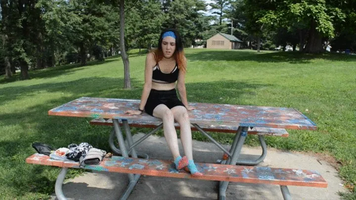 Alice poses her hot and sweaty feet at a park during the summer