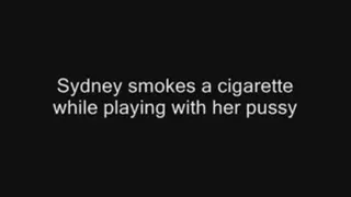 Sydney smokes a cigarette while playing with her pussy and talking very dirty