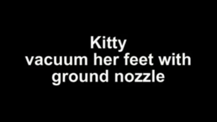 Kitty vacuum her feet with ground nozzle