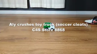 Aly crushes toy truck (soccer cleats)