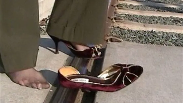 Maroon high heels on the light rail track - Shoeplay