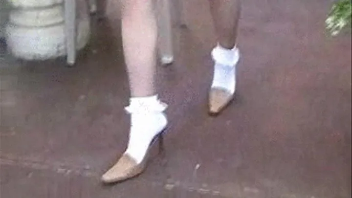 High heel mules with ankle sox on a patio