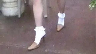 High heel mules with ankle sox on a patio