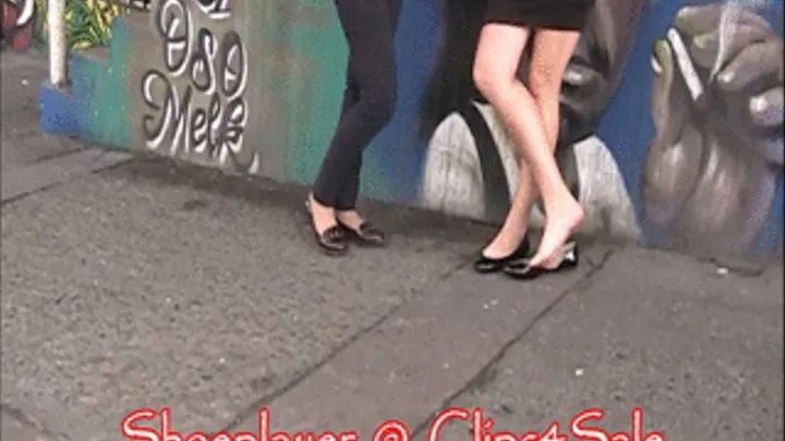 2 girls in flats waiting for the bus