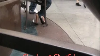 Silver flats, jeans & nylons at mall bench