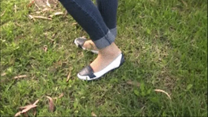 Blue & white flats crushed barefoot in the grass