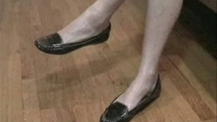 Black loafers barelegged with hand lotion