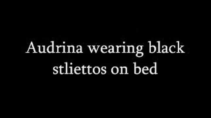 Audrina wearing black stilettos on bed