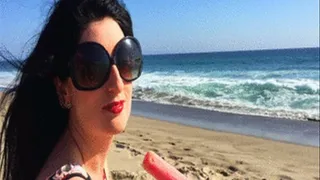 Luscious Lopez licks popsicle on beach