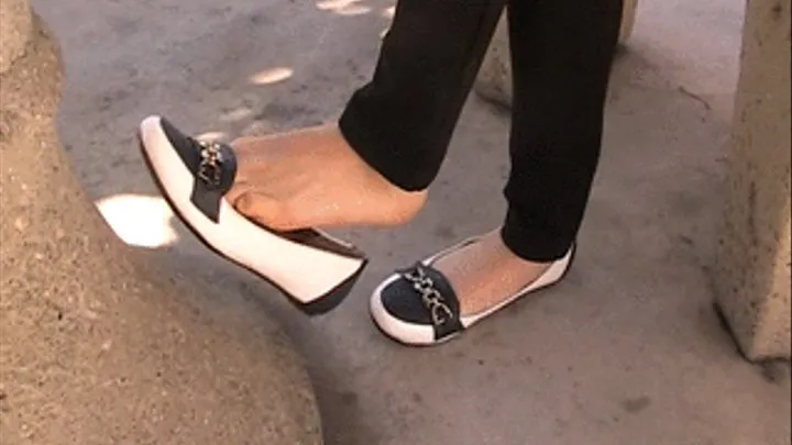 New black & white trimmed flats barefoot