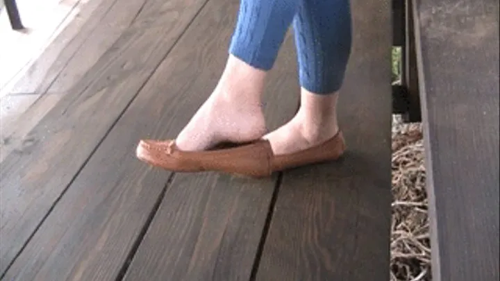 Barefoot shoeplay with penny loafers in wooden bleachers