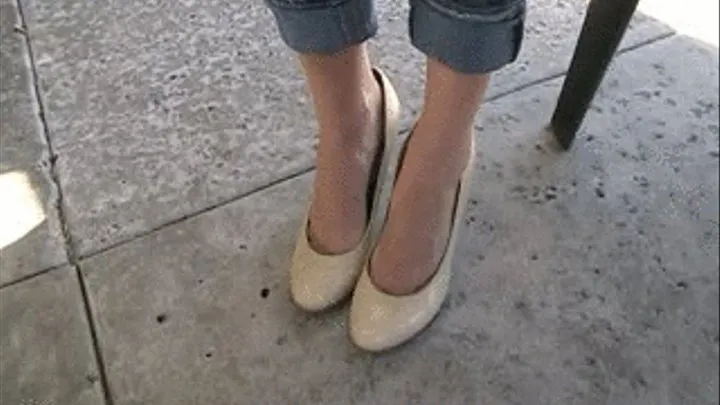 Beige high heels barelegged in jeans