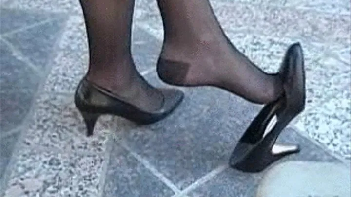 Black high heels dipping at a cafe' table