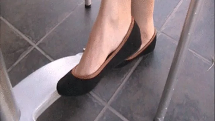 New black suede flats with trim barefoot under the table ~ side