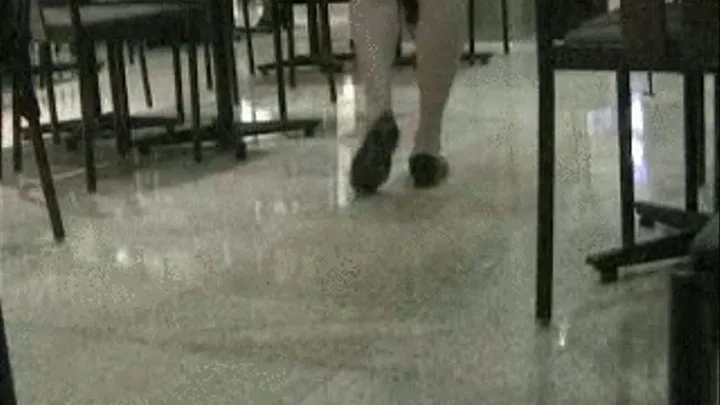 Black penny loafers at the food court