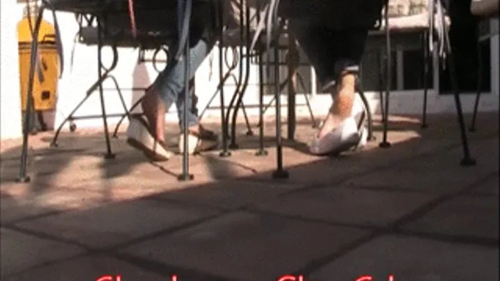 2 girls barefoot shoeplay under chair in boat shoe @ lunch