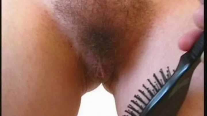 Hairbrush across her cunt