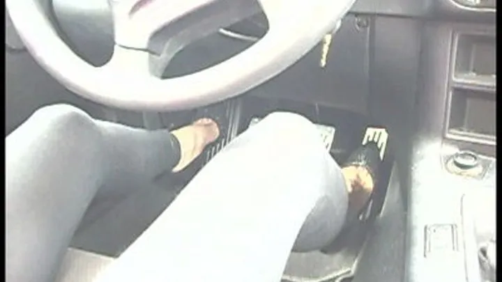 she is driving in her 5inch black Cobra heels