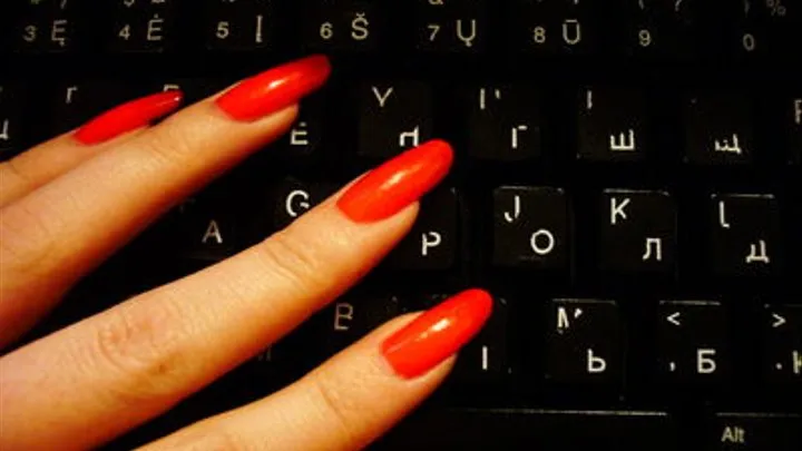 Red nail typing on a keyboard