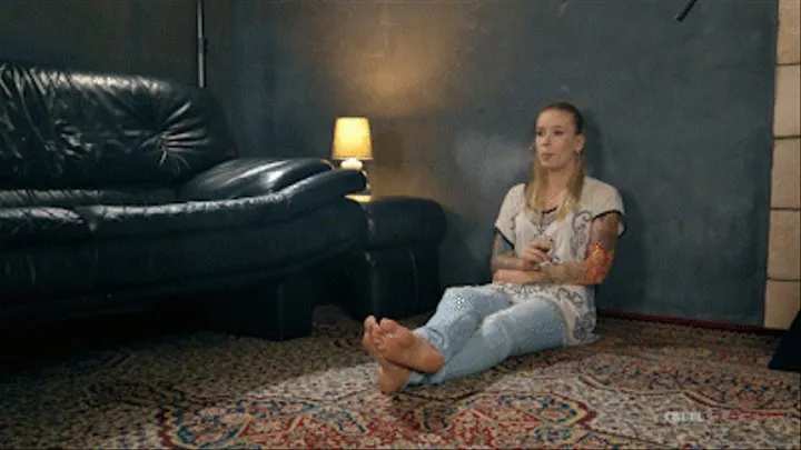 Smoking barefoot in jeans