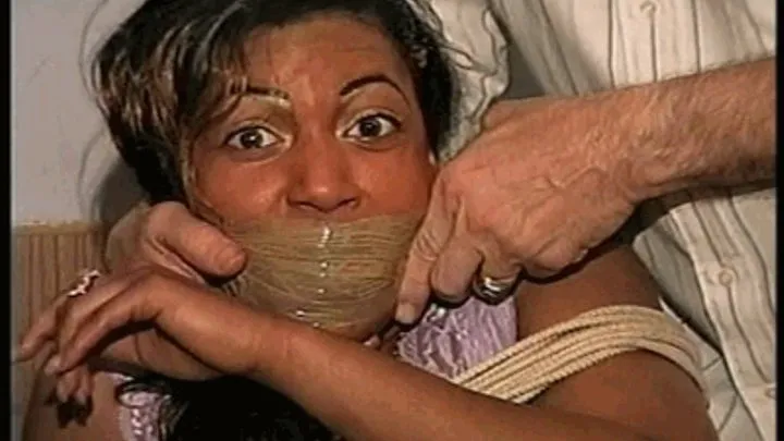 27 Yr OLD BEAUTY SALON OWNER HAS PANTY THONG STUFFED IN HER MOUTH, WRAP TAPE GAGGED, GAG TALKING, HANDGAGGED, BAREFOOT, TOE-TIED AND TIGHTLY HOG TIED ON THE BED