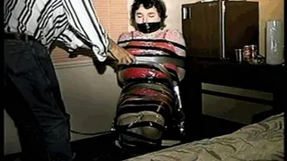 25 Yr OLD 2nd GRADE SCHOOL TEACHER IS MUMMY WRAPPED AND GAGGED WITH PLASTIC WRAP, BLACK ELECTRICAL TAPE AND SILVER DUCT TAPE ON A CHAIR