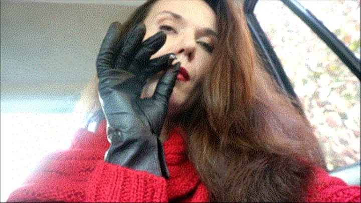 Smoking in red sweather and leather glove.
