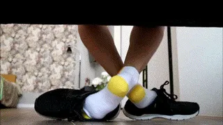 White socks with a yellow heel play with men shoes