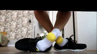 White socks with a yellow heel play with men shoes
