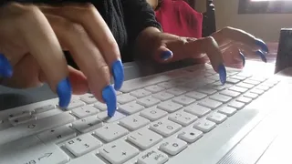 Long finger nails tapping on keyboard