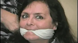 50 Yr OLD TRAVEL AGENT GETS LEATHER GLOVE HANDGAGGED, RAG STUFFED IN MOUTH, CLEAVE GAGGED, TELLS TRUE BONDAGE STORY, GAG TALKING AND TIGHTLY TIED TO A CHAIR