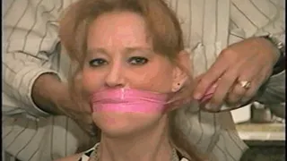 41 Yr OLD RED HEADED FAMOUS FASHION MODEL GETS HANDGAGGED, MOUTH STUFFED, WRAP BONDAGE TAPE GAGGED AND TIGHTLY TIED TO A CHAIR