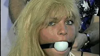 GREEN EYED, BLOND BOMBSHELL, CROTCH ROPED AND BALL-GAGGED