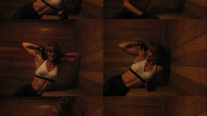 Veronica in the sauna, wearing a white workout top and black athletic pants