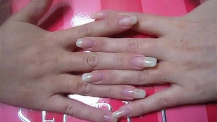 Clear Nails Tapping On Pink Box