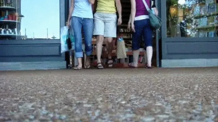 Candid women walking in and out of a store